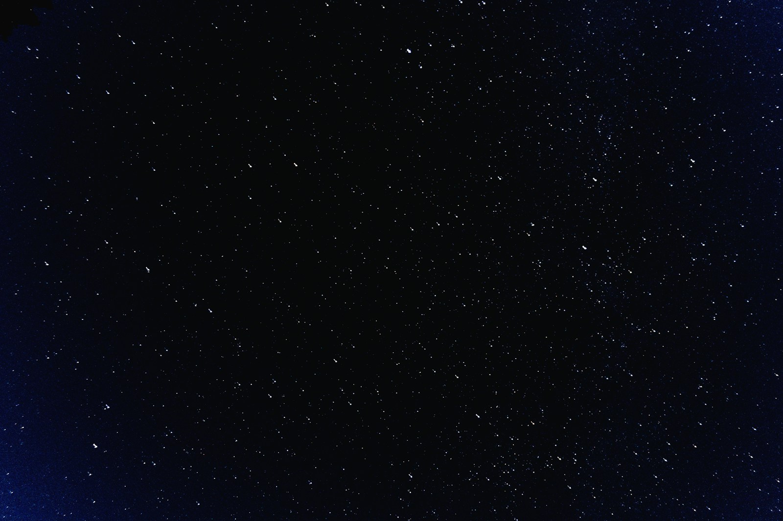 A field of stars across a deep blue night sky